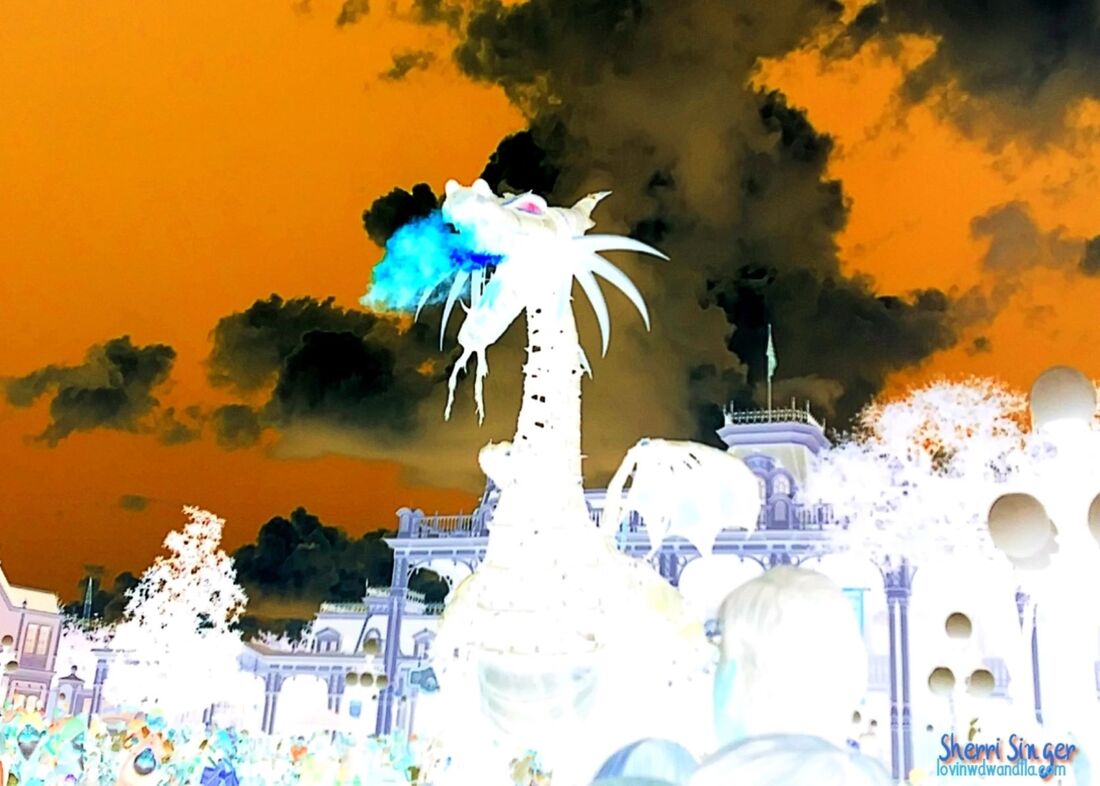 If you have seen the Festival of Fantasy Parade at Walt Disney World, then you know who my Cold Fire Dragon Lady is. She is epic and magnificent. I have plenty of shots of her in all her darkness (and one for sure on Etsy shortly), but for this shot, I decided to play with an amazing effect that would invert the colors into something no one has really ever seen before. Certainly no one has watched her breathe blue fire or cold fire as I call it. I also tweaked and played with the color in the crowd and sky to bring out what to me, looks like a perfect blend of scary and warm all at once. For more lovinwdwandfla.com